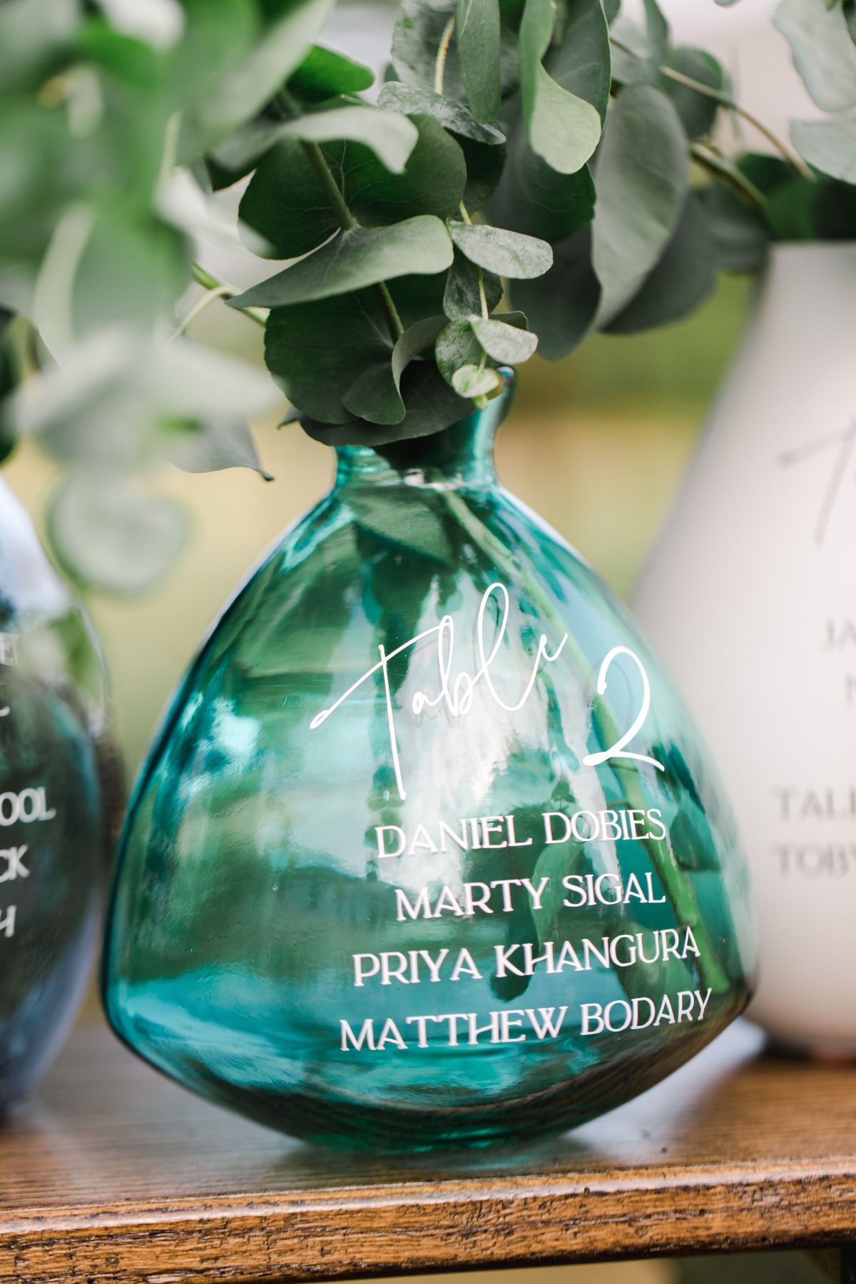Close-up of colorful vases used for seating assignments