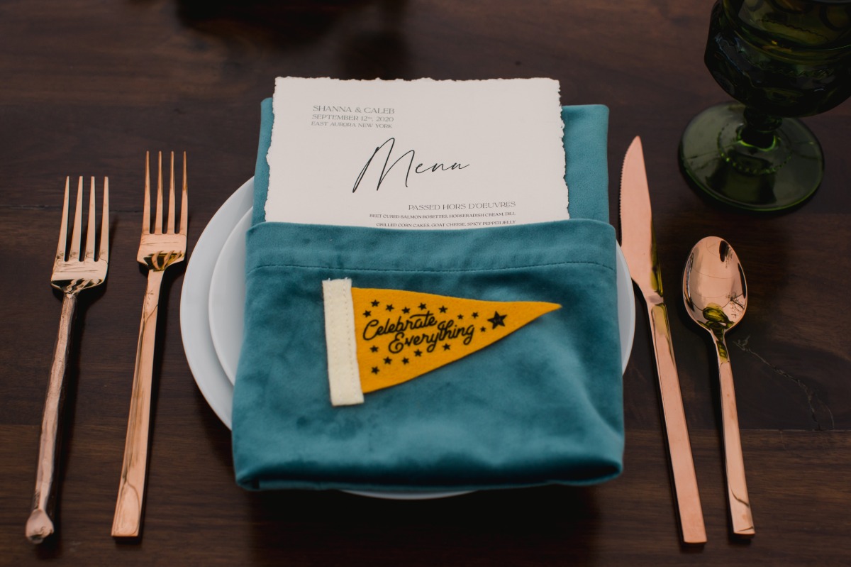 Aerial photo of gold flatware and place-setting
