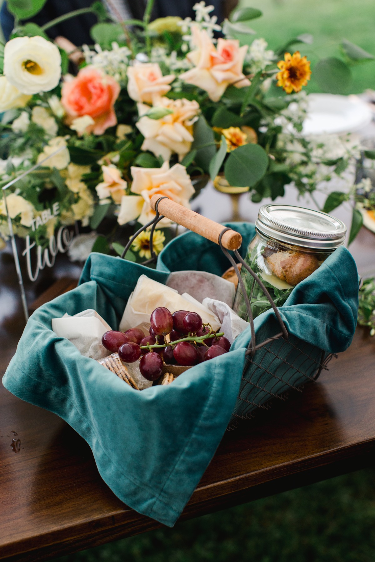 Close-up of reception table arrangement and charcuterie basket