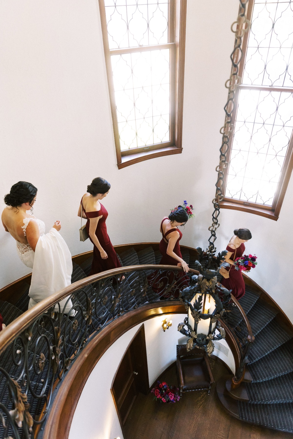 Bride and bridesmaids walking down staircase