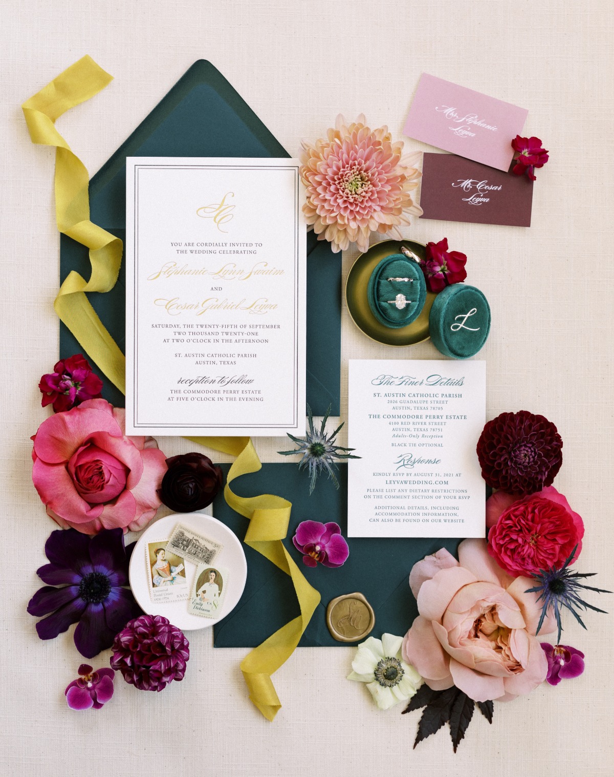 Aerial photo of stationery, rings, flowers, and ribbon