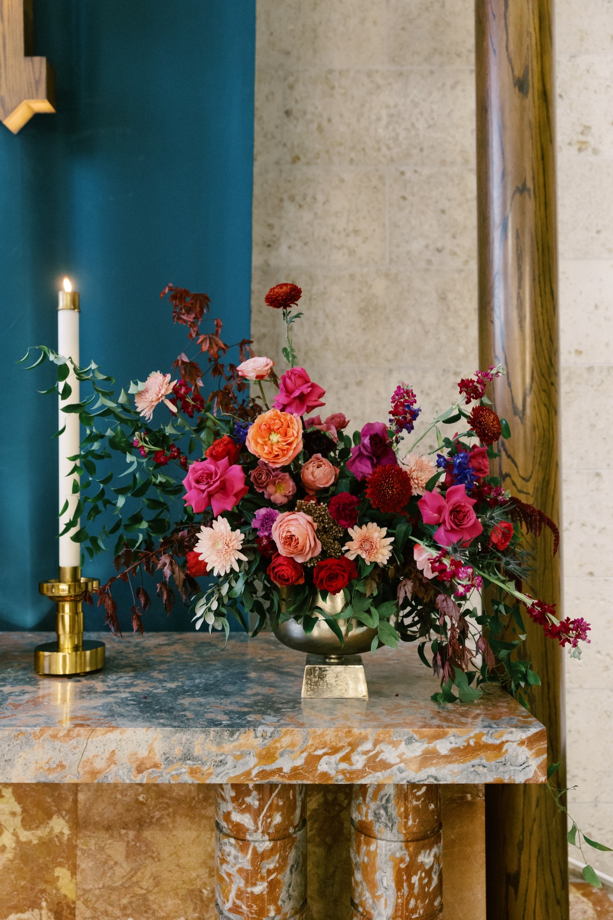 Floral arrangement on marble table with candle