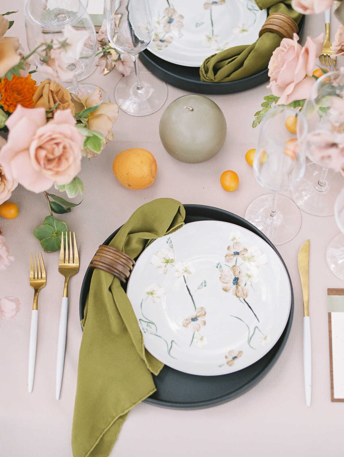 Place setting with gold utensils and floral patterned plates