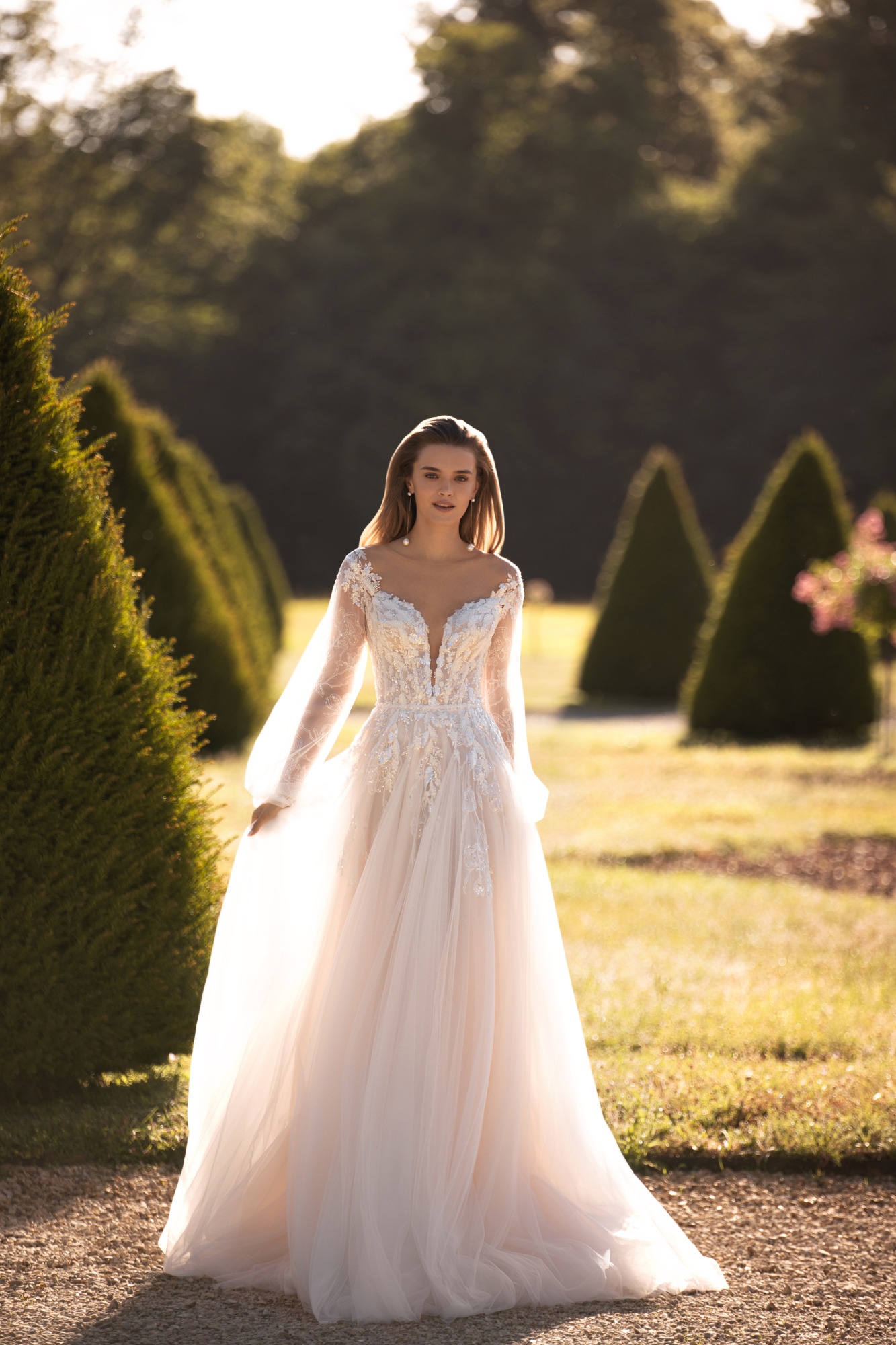 wedding dress with a plunging neckline and princess sleeves