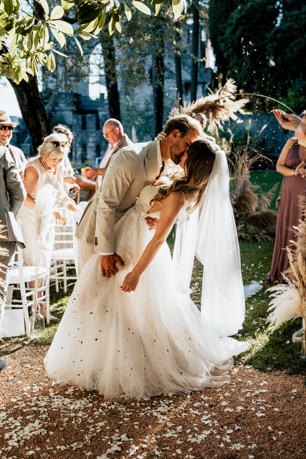 romantic wedding kiss with floral toss