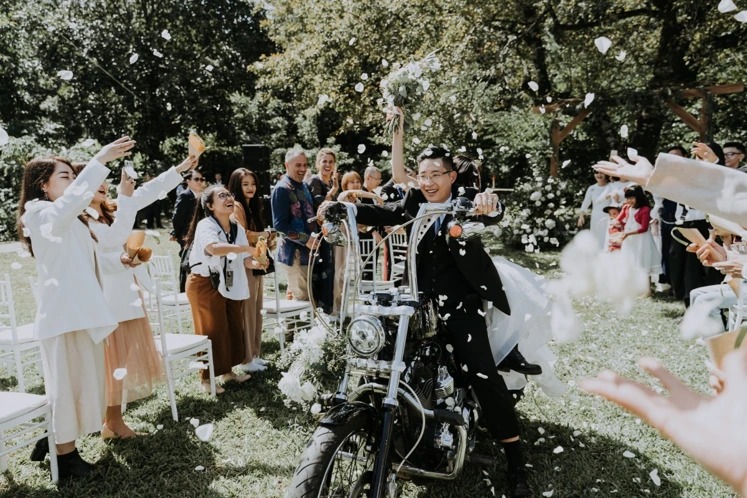 riding motorcycle down the aisle at wedding