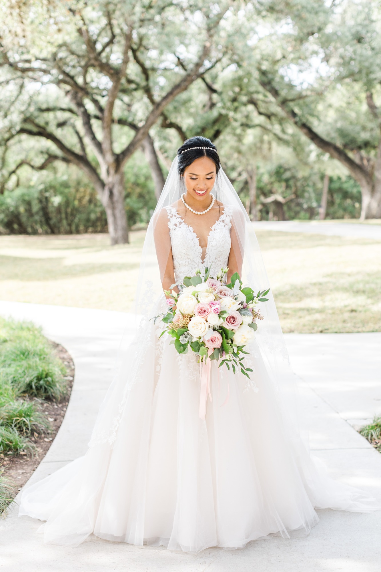 bride is wearing pearl head crown and pearl wedding necklace
