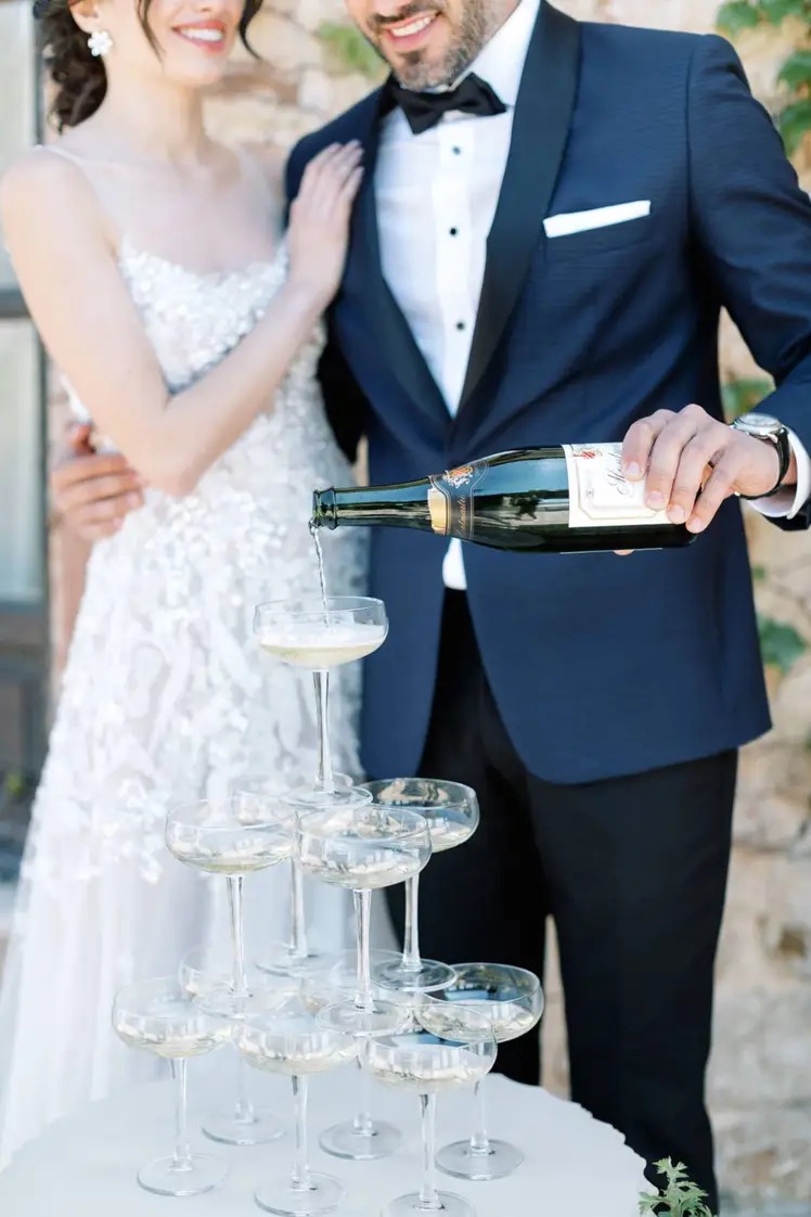 couple pouring in a champagne tower