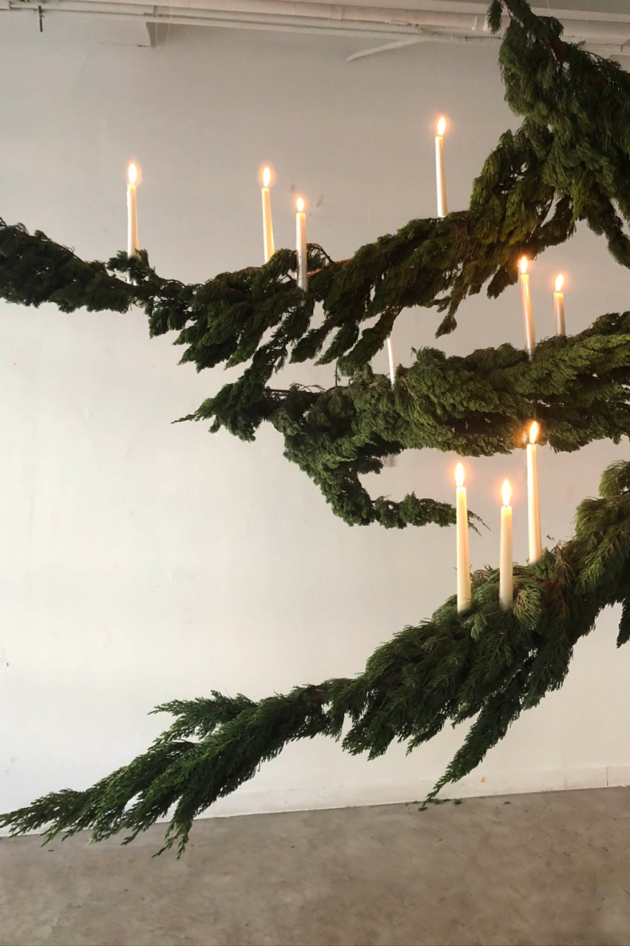 pine branch installation with candles for a modern winter wedding 