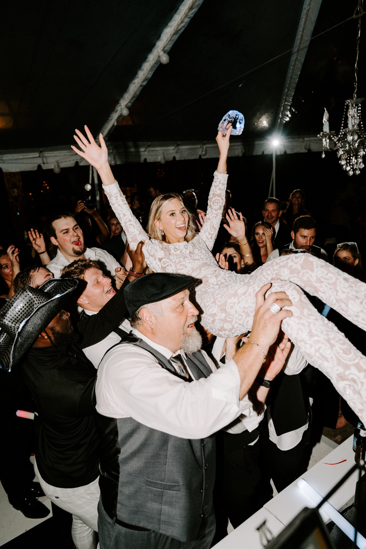 Bride crowdsurfing at reception