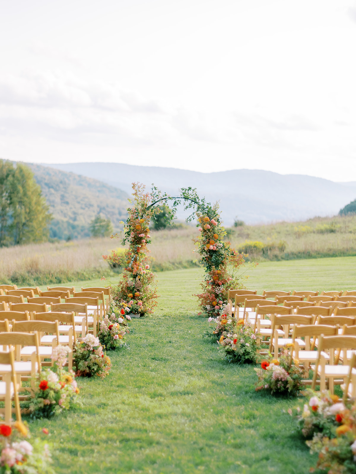 wedding aisle with floral arch