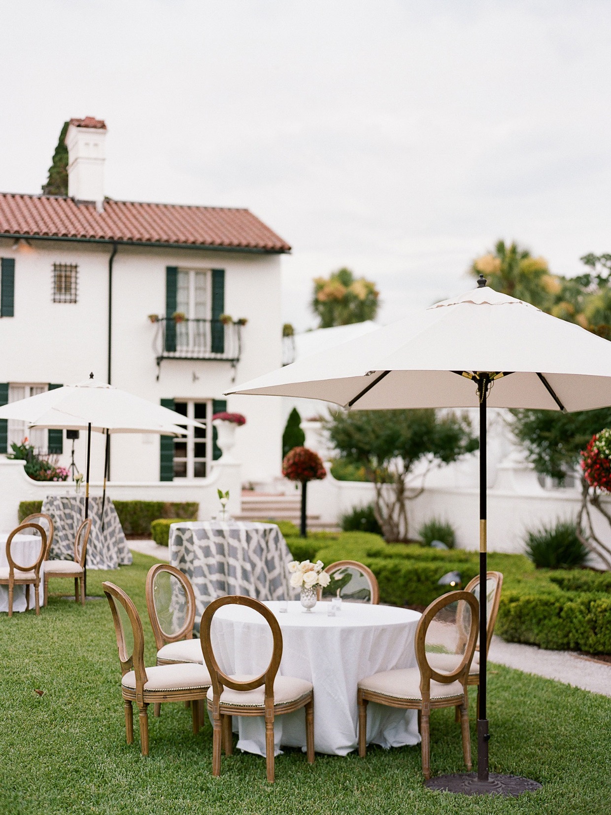 Elegant outdoor wedding reception with white table and chairs