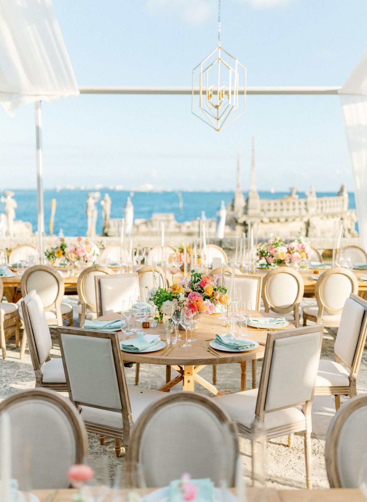 Elegant seaside wedding reception with floral centerpieces