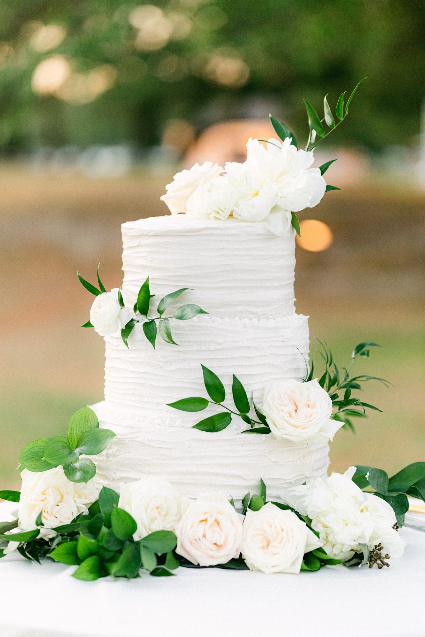 all white three tier wedding cake