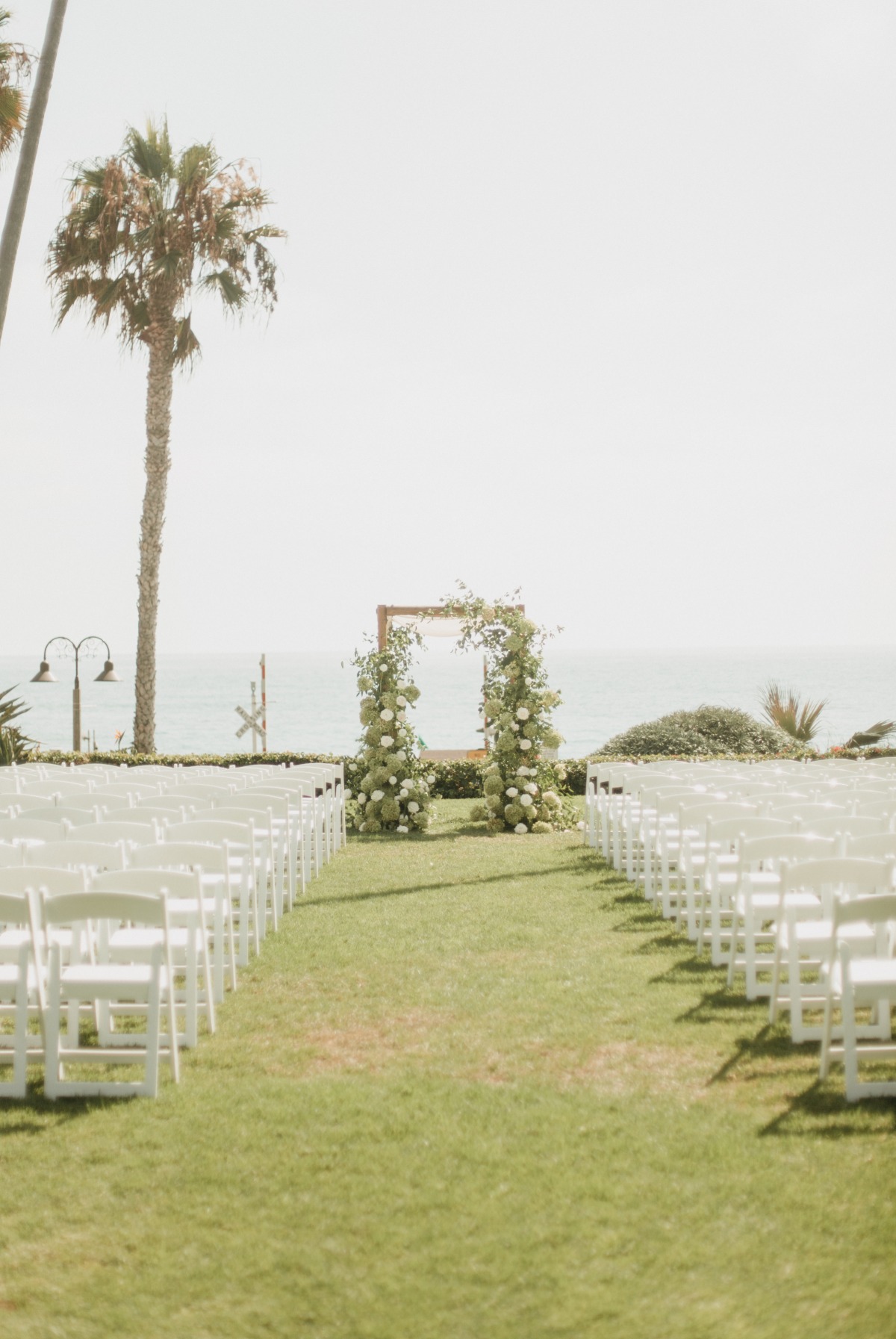 outdoor wedding aisle with floral arch