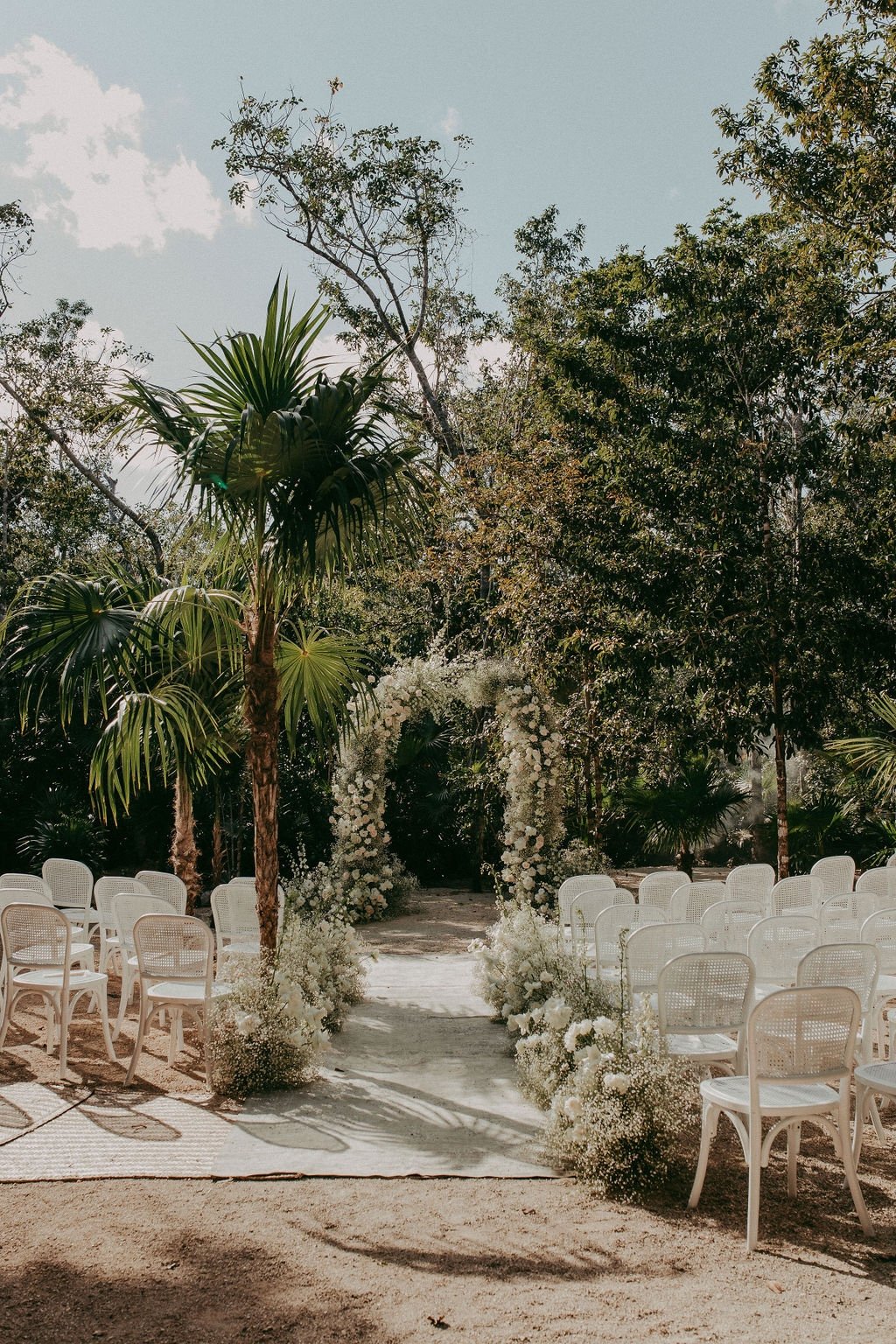 beach jungle destination wedding ceremony with floral arch