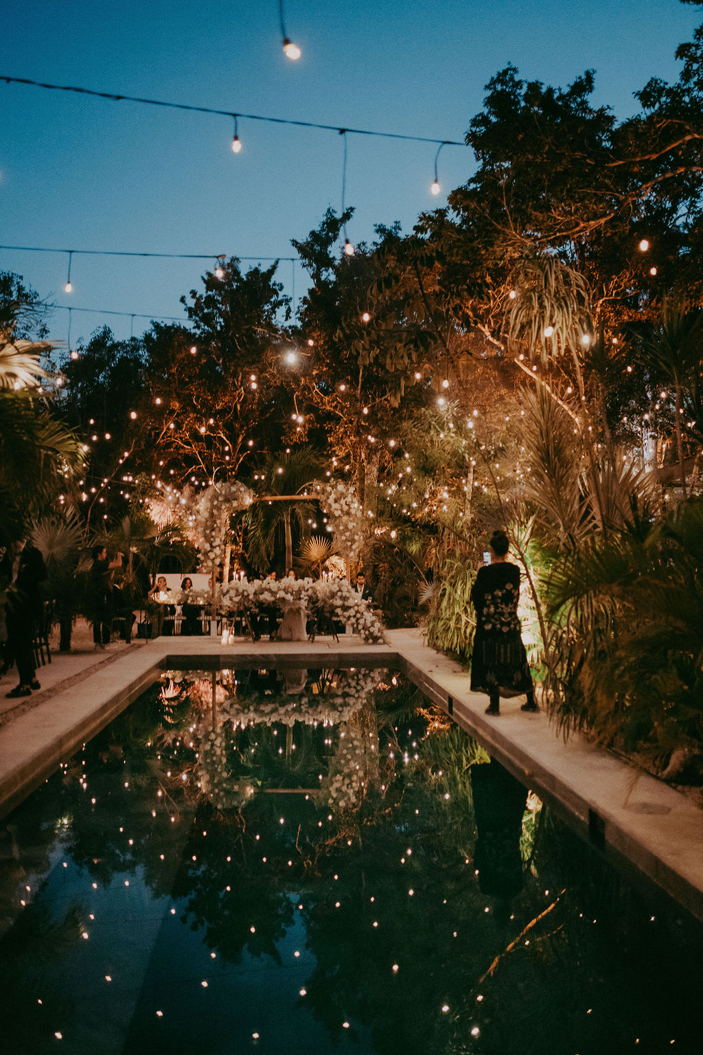twinkle lights over pool for wedding reception in Mexico