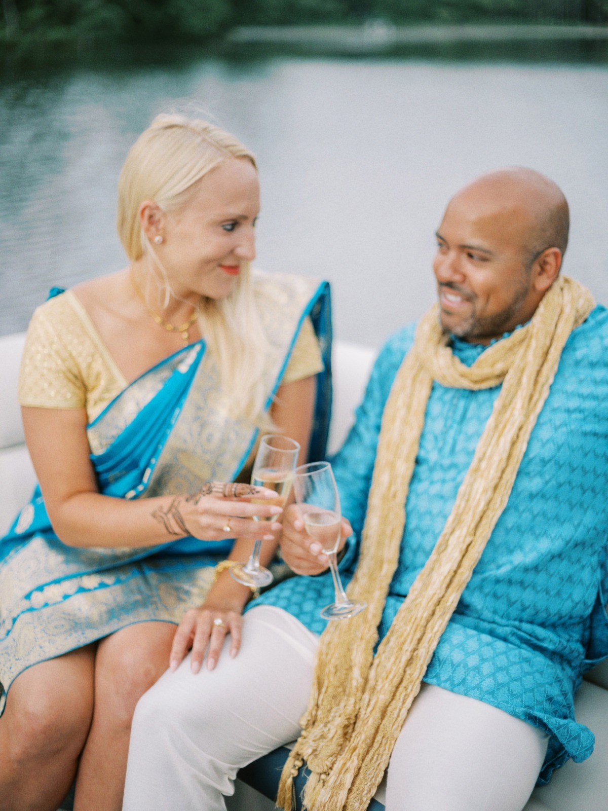 bride and groom on boat in Indian wedding attire 
