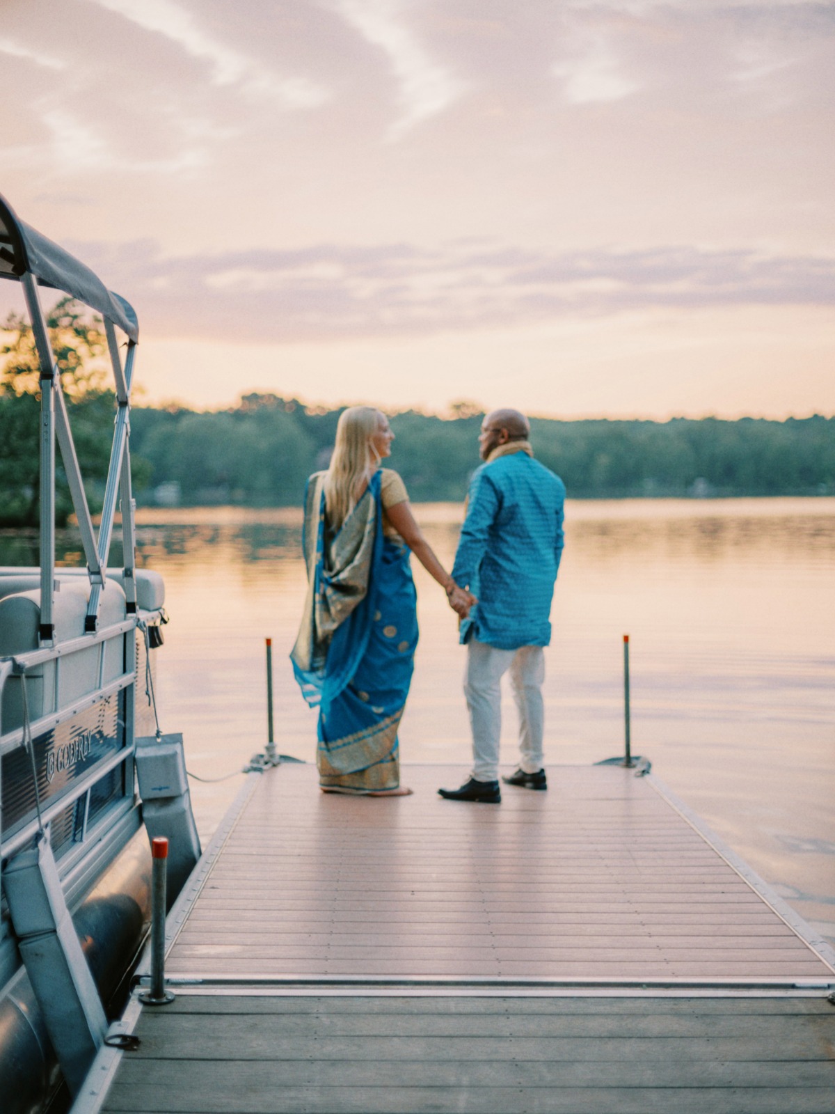 bride and groom on dock in Indian wedding attire in shades of teal