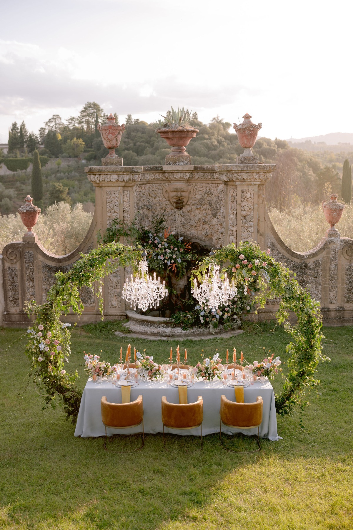 Tuscan garden wedding with modern chairs and chandeliers