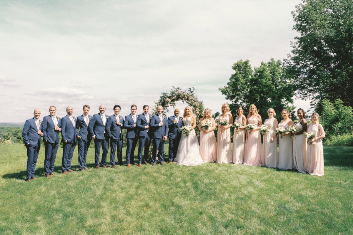 bridesmaids in blush and groomsmen in blue