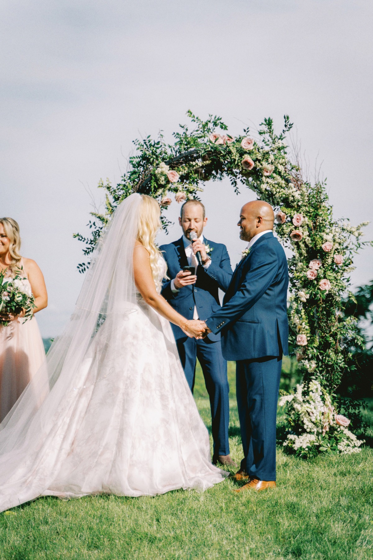 outdoor ceremony with floral arch