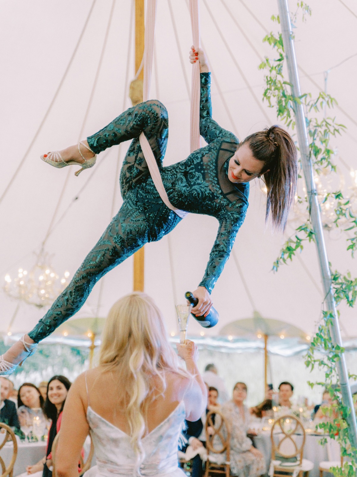 aerial artist pouring champagne for bride