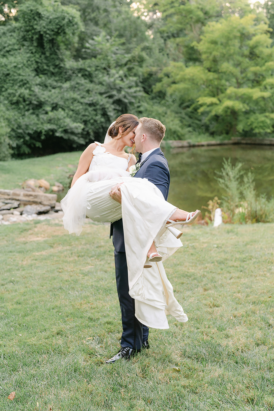 bride and groom at garden wedding with pond