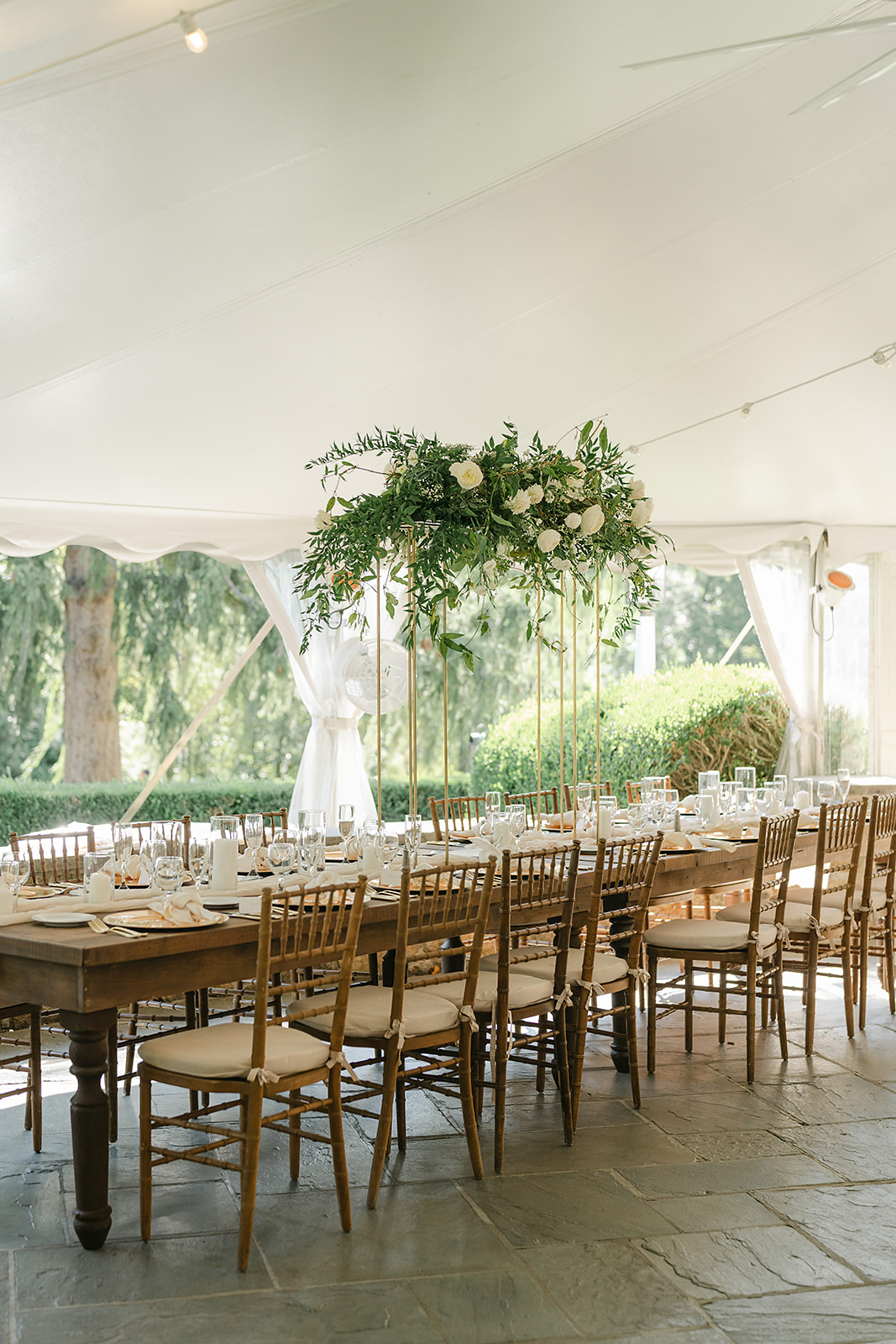 white tented reception with tall centerpieces