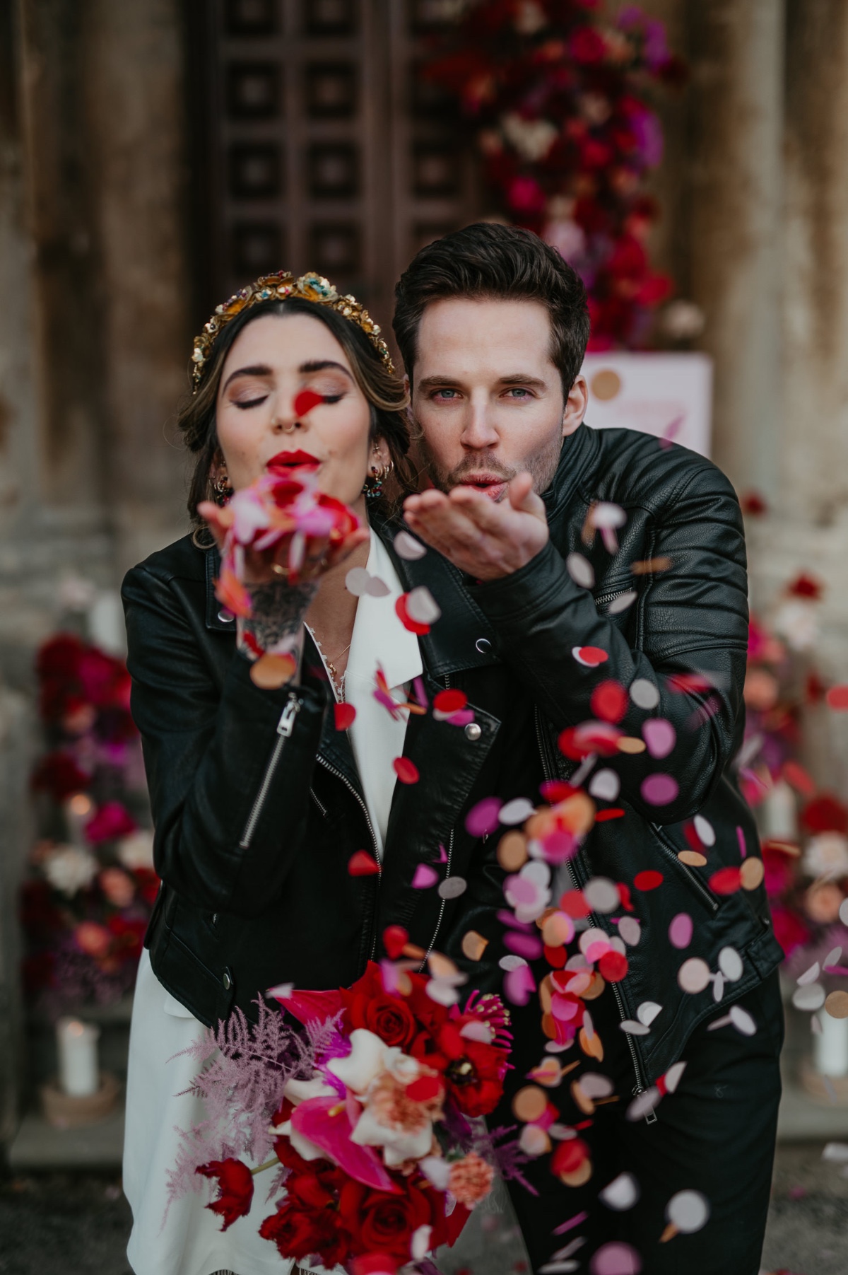 bride and groom wearing leather jackets with confetti cannon exit