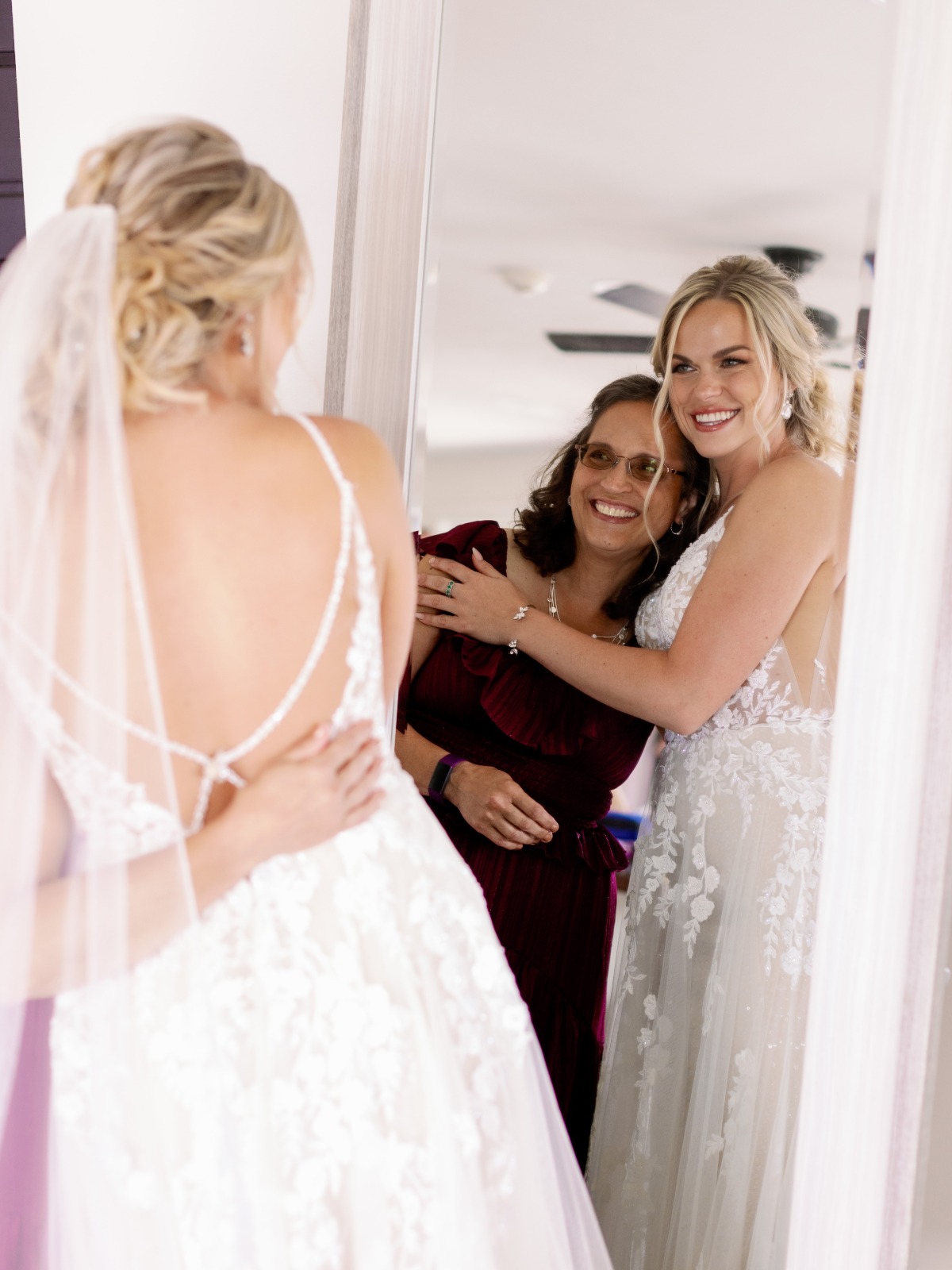 Bride and mother getting ready in mirror