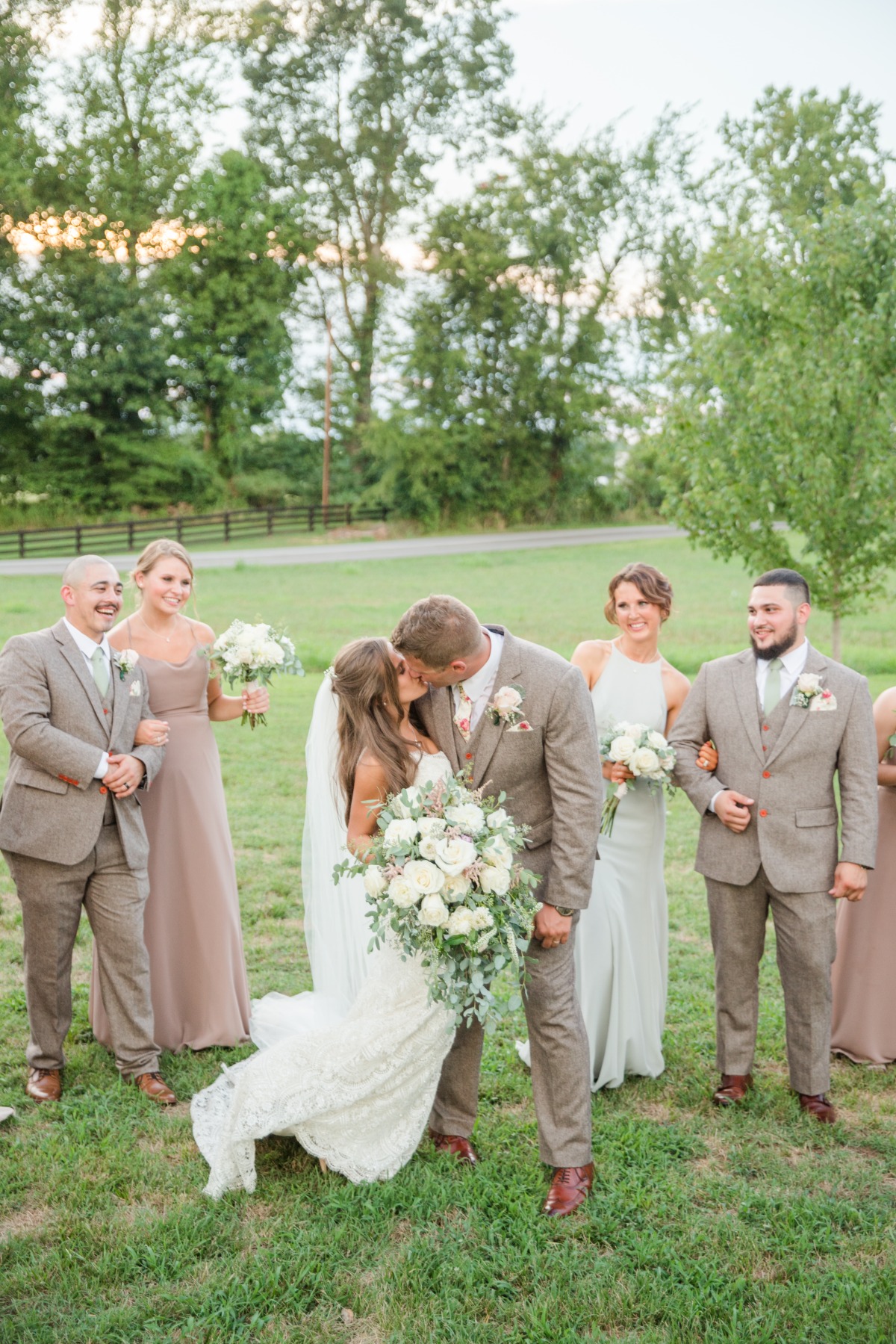 Bridal party kissing photo 