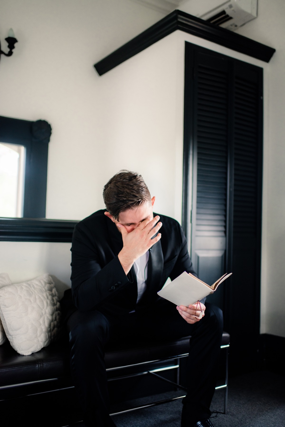 Emotional groom reading letter from bride
