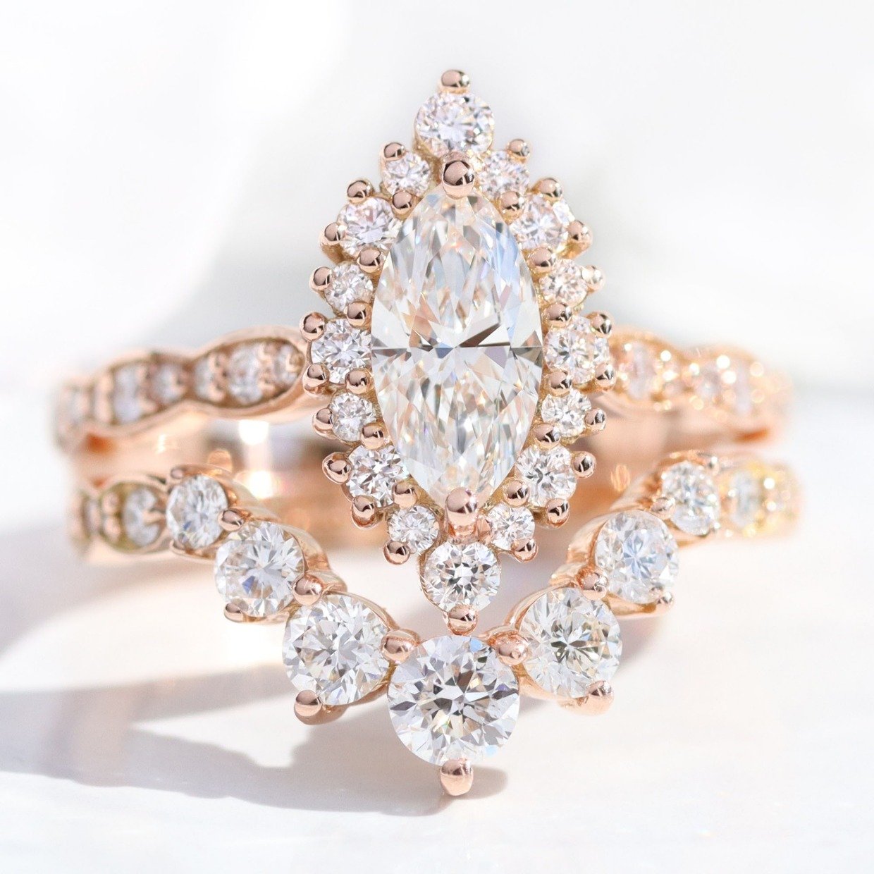 beautiful Marquis diamond engagement ring and matching band in rose gold with halo by Lámore Design