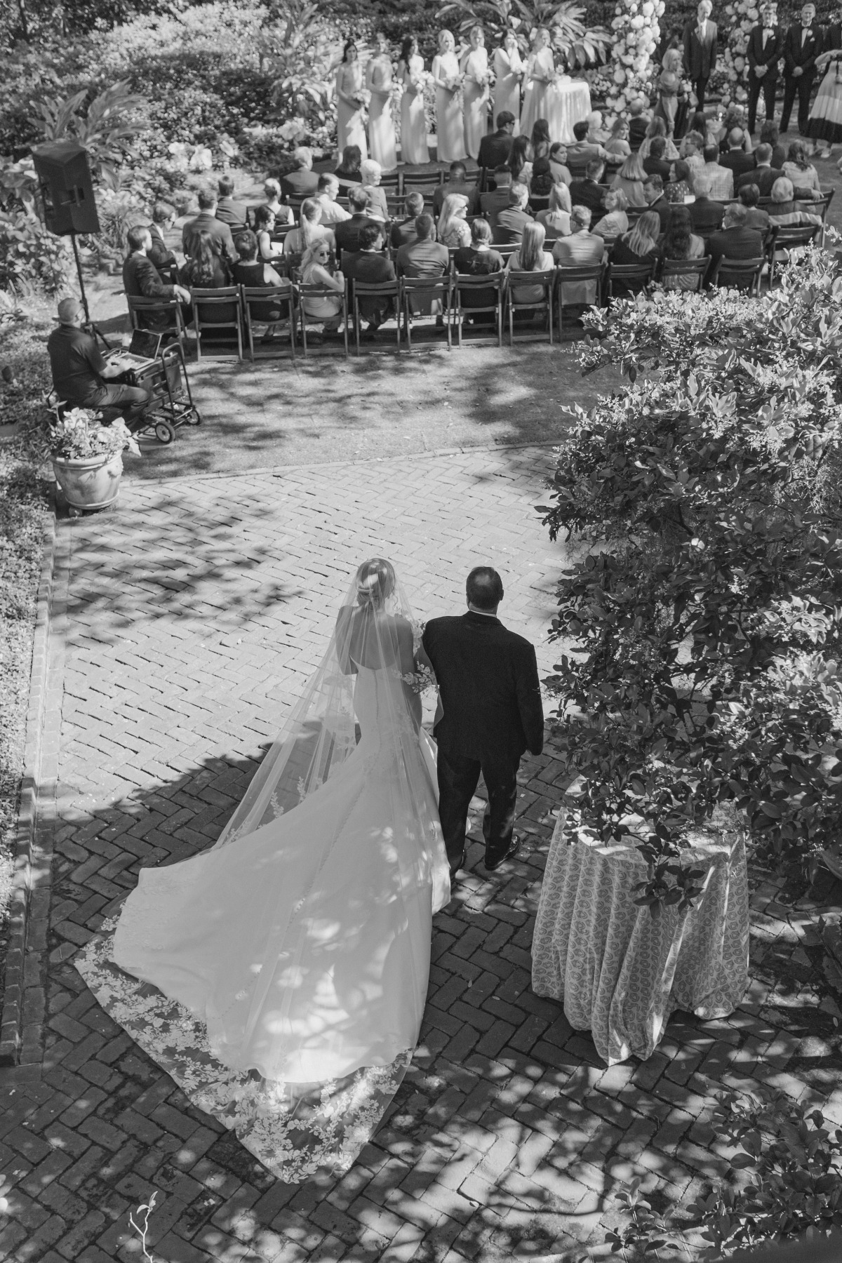 bride walking down the aisle with Father