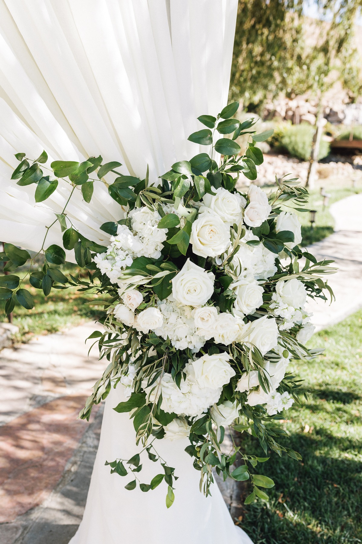 white rose wedding ceremony arrangement