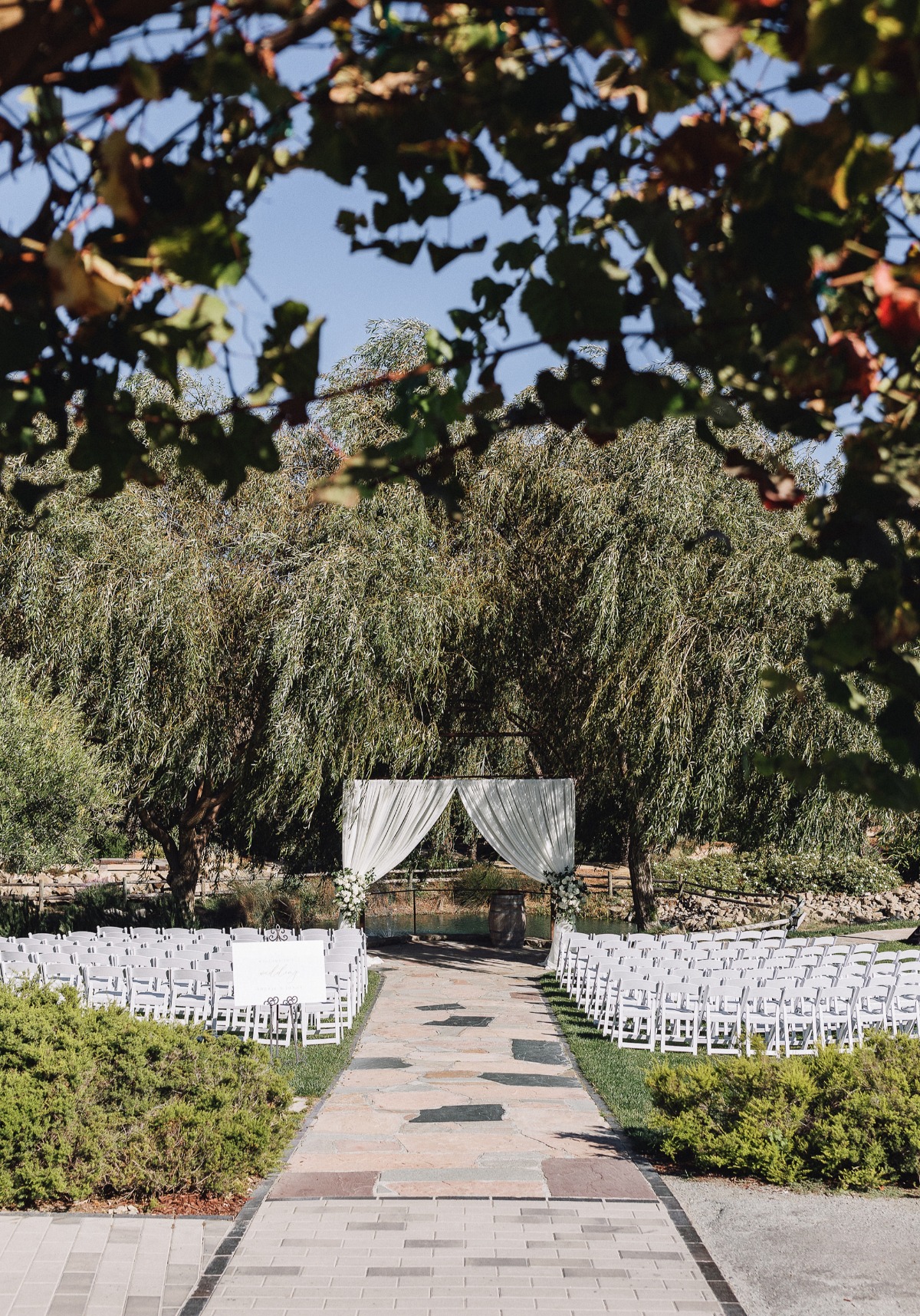 all white outdoor wedding ceremony at vineyard