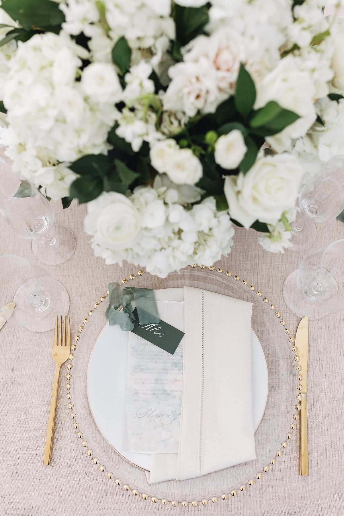 white rose table centerpieces for wedding with gold and green accents
