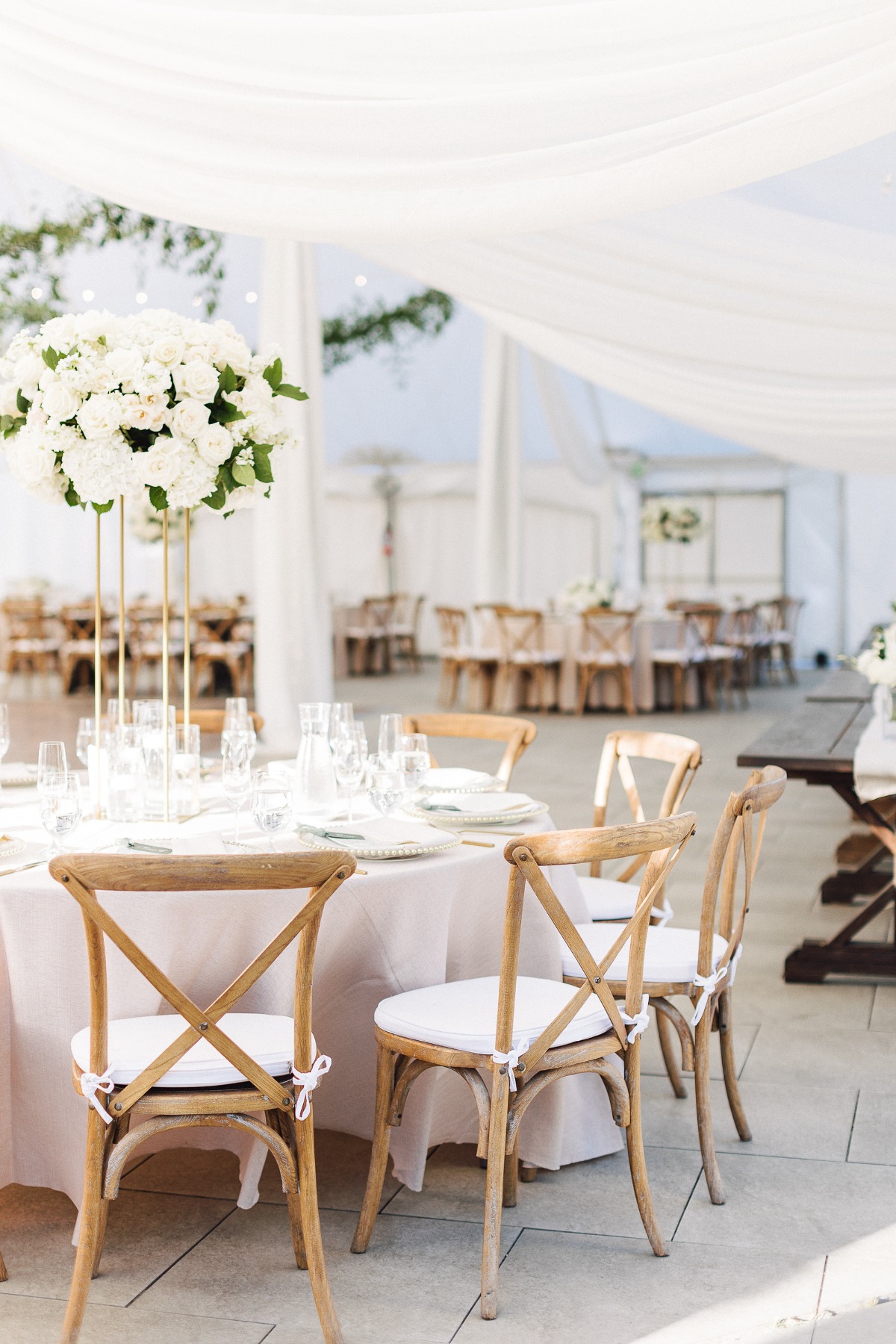 wood farm chairs and white rose centerpieces wedding reception