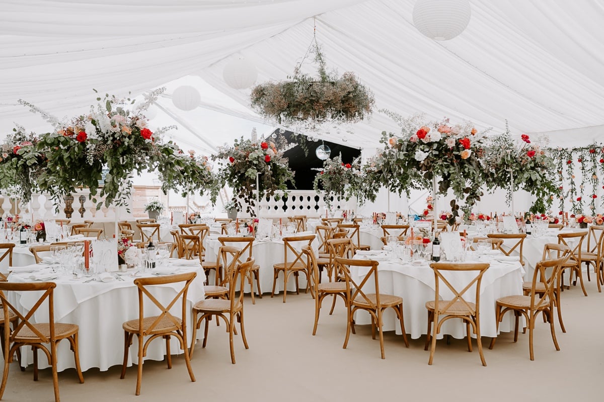 tented wedding reception with hanging floral installations