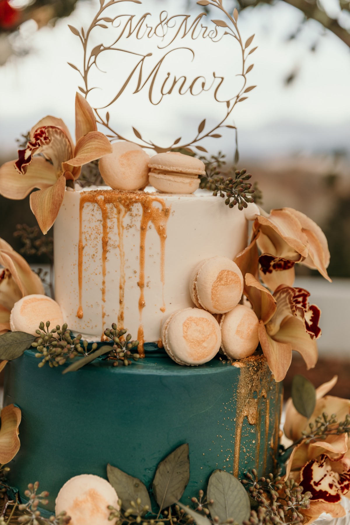 teal and white wedding cake with macarons