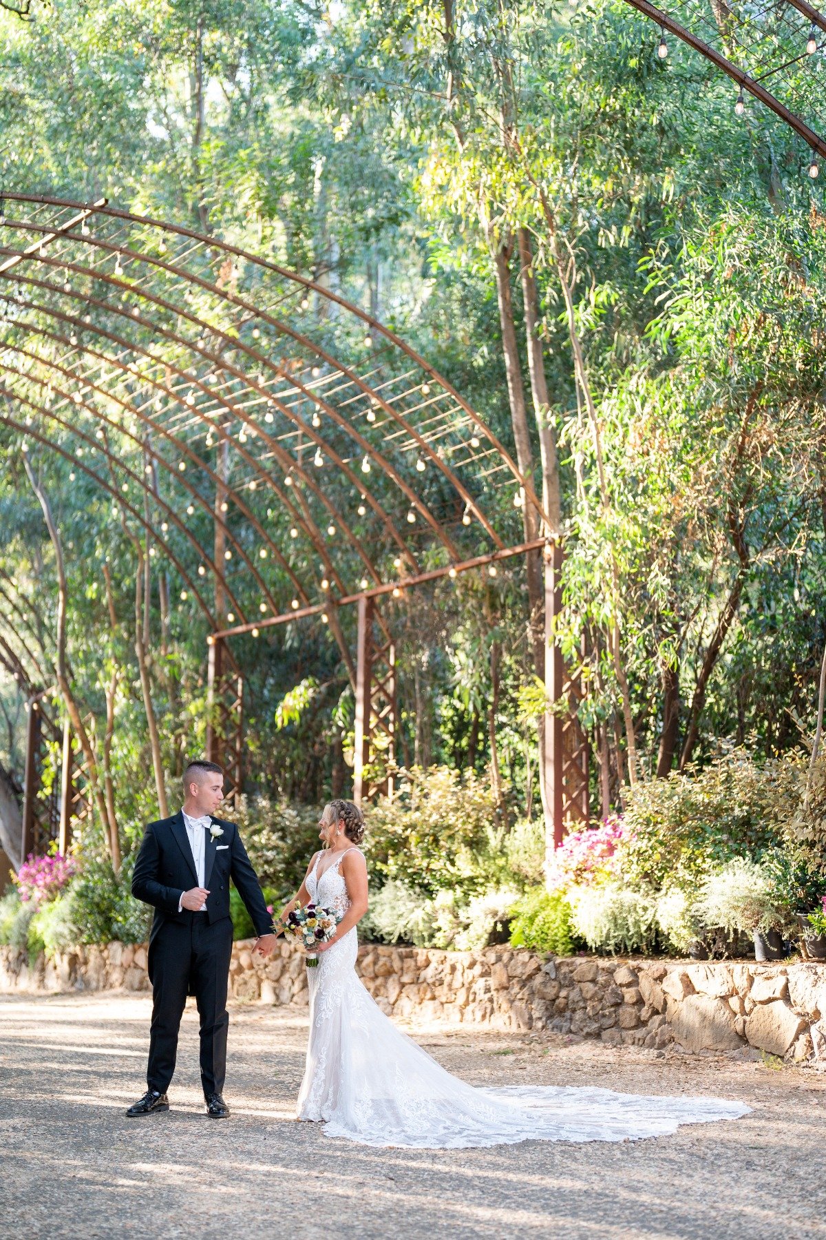 bride and groom walk into their woodland reception