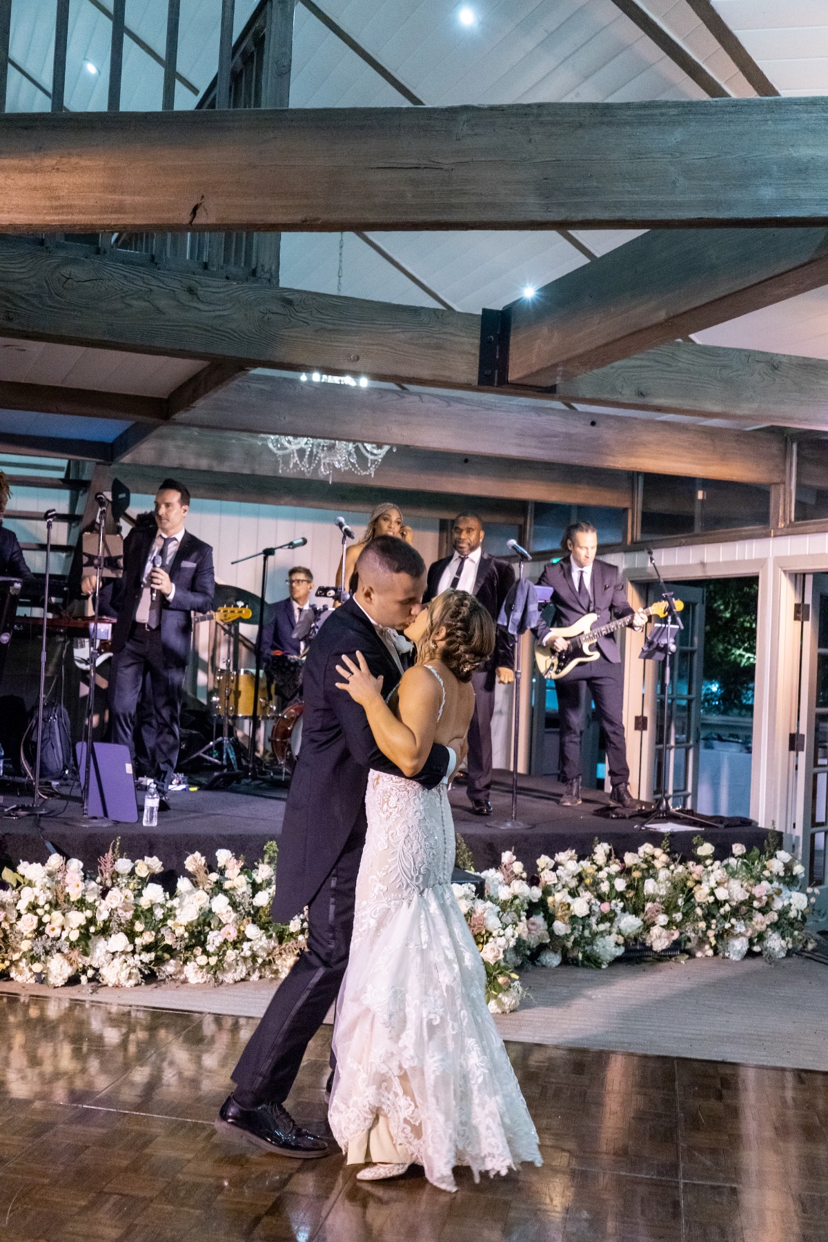 bride and groom dance with a live band