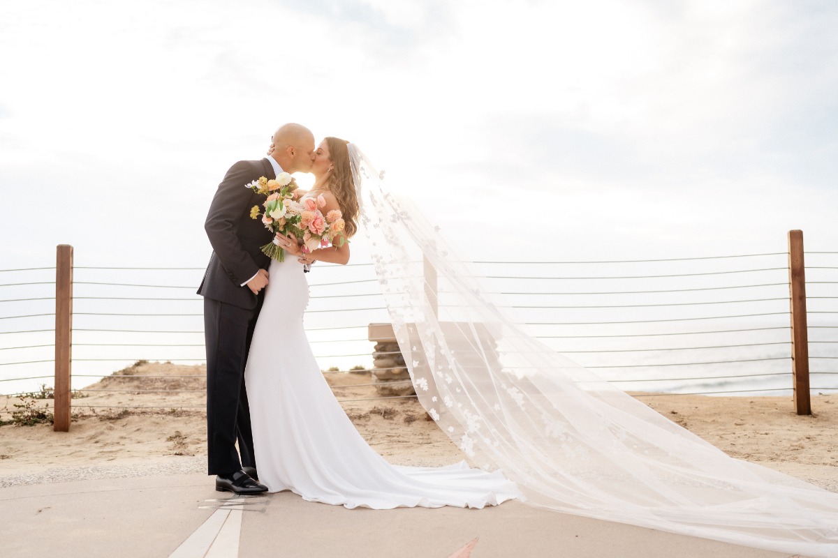 Kiss at beach resort wedding
