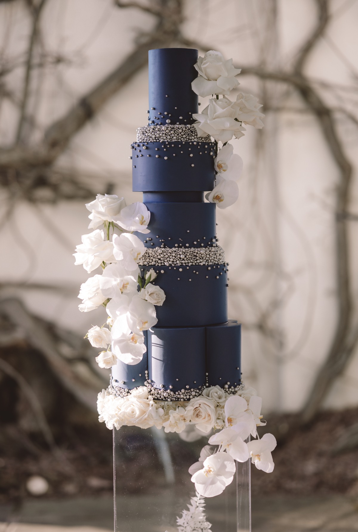 navy blue wedding cake with live flowers