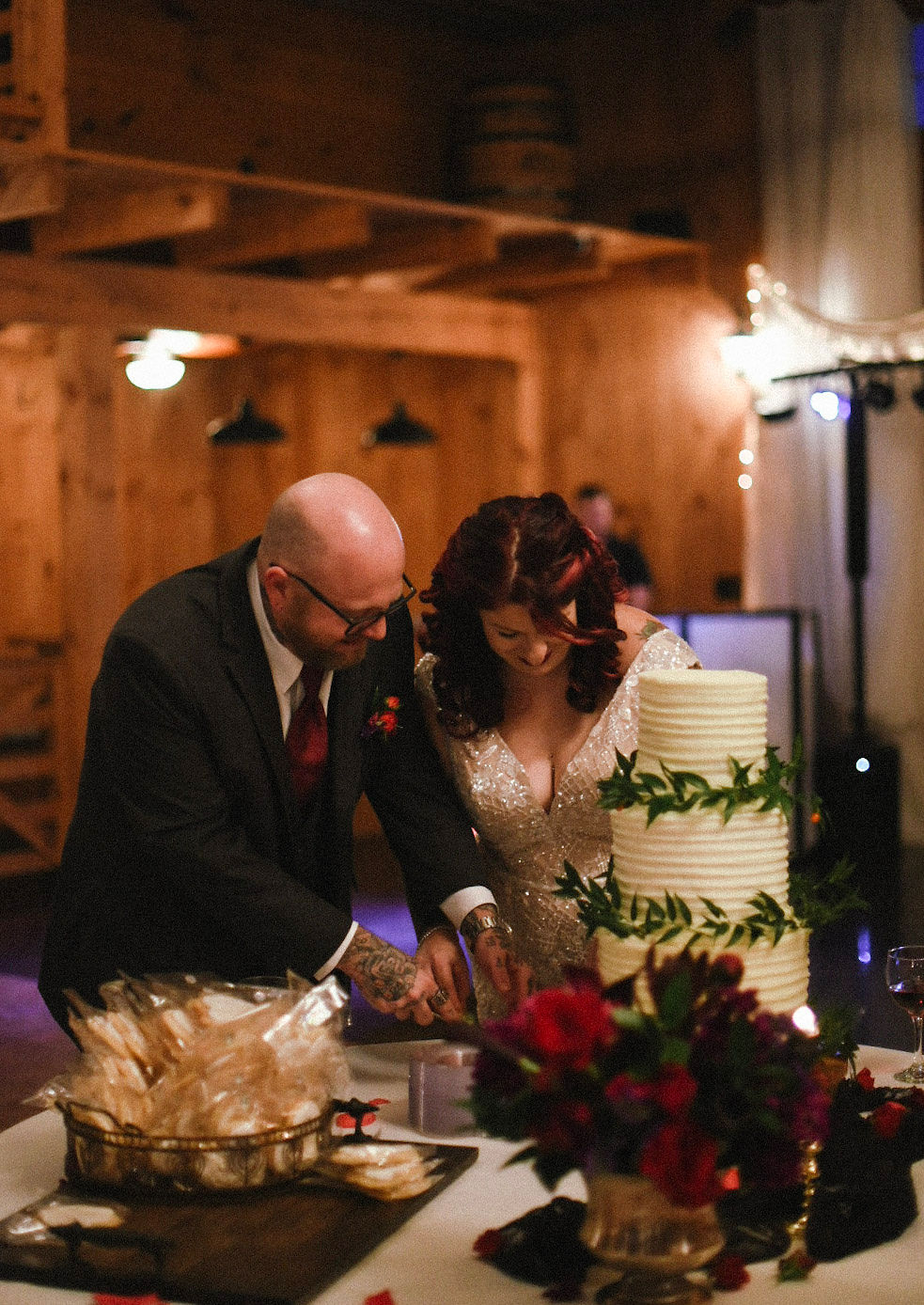 three tiered wedding cake with greenery
