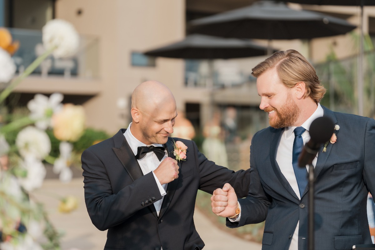 Groom fist bumping at the altar