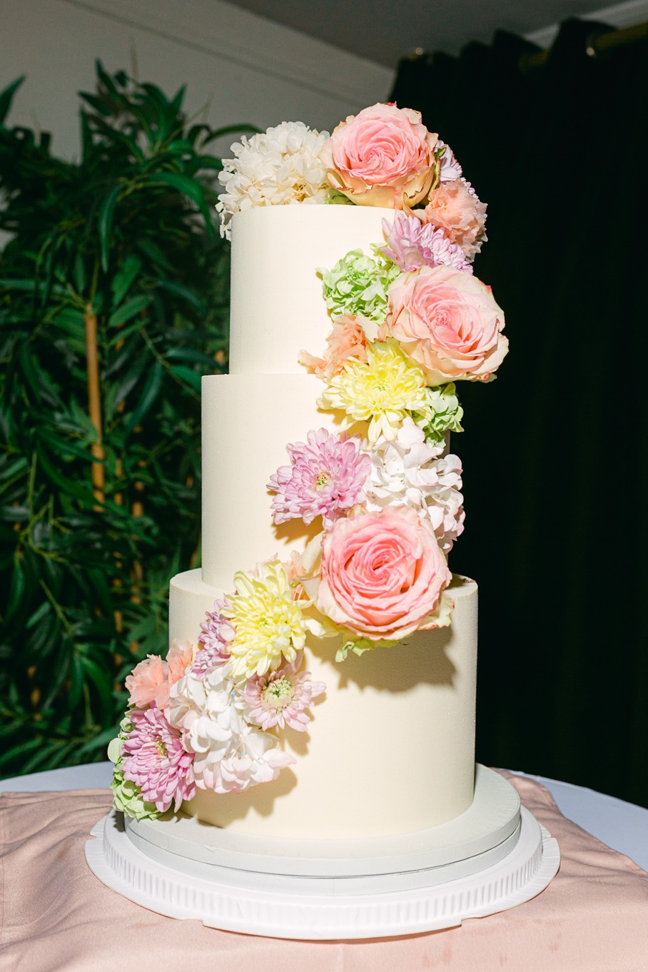 wedding cake with a rainbow of flowers