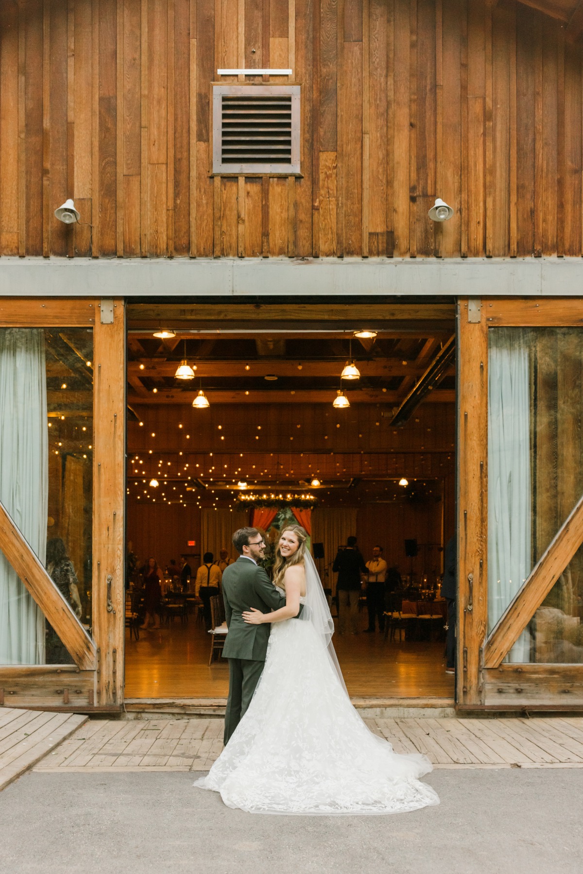 bride and groom at rustic barn wedding