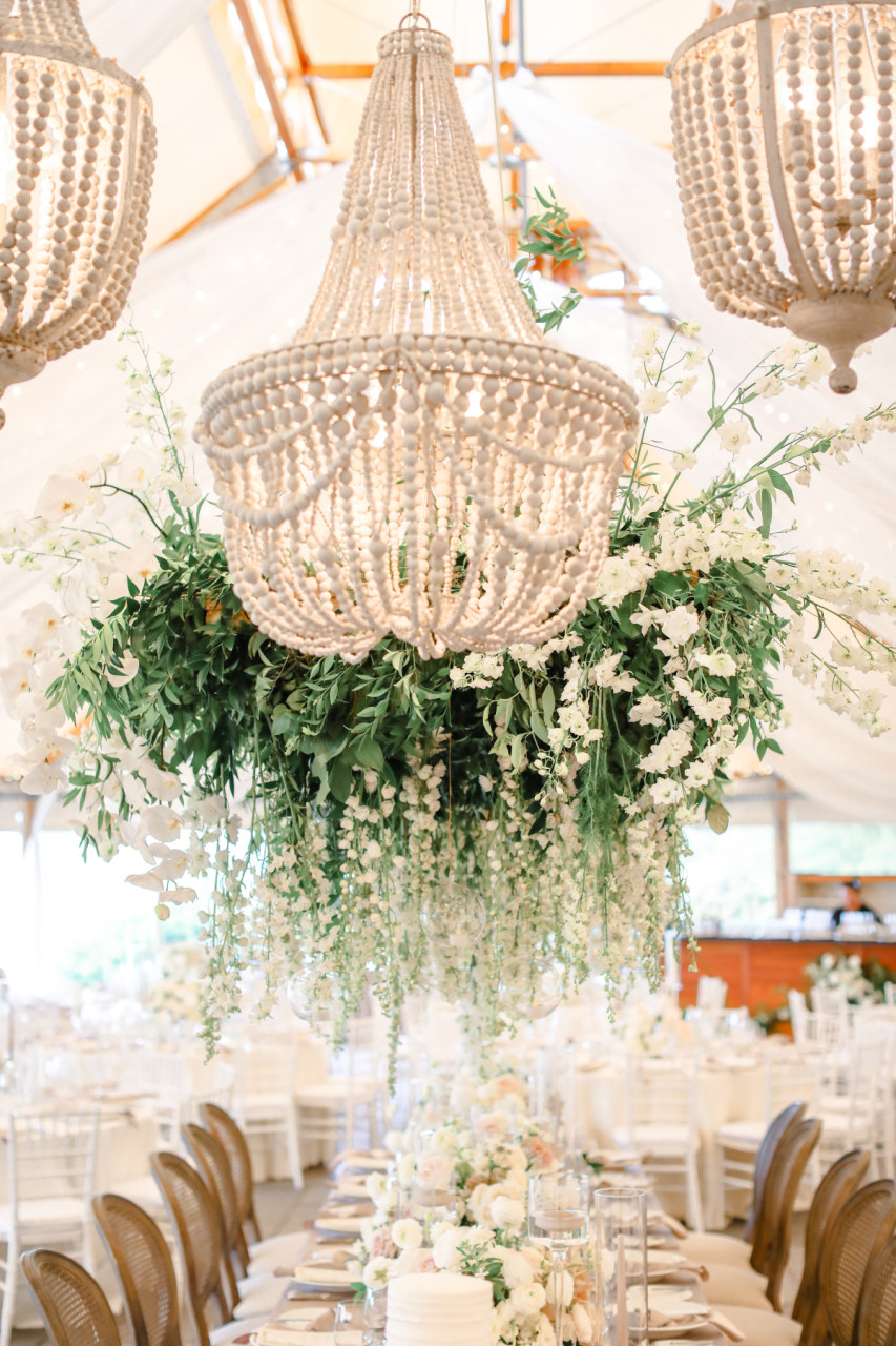 wood bead chandeliers in tented reception